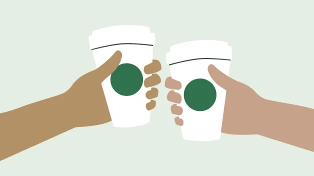 Two cheering hands. Each hand is holding a Starbucks cup