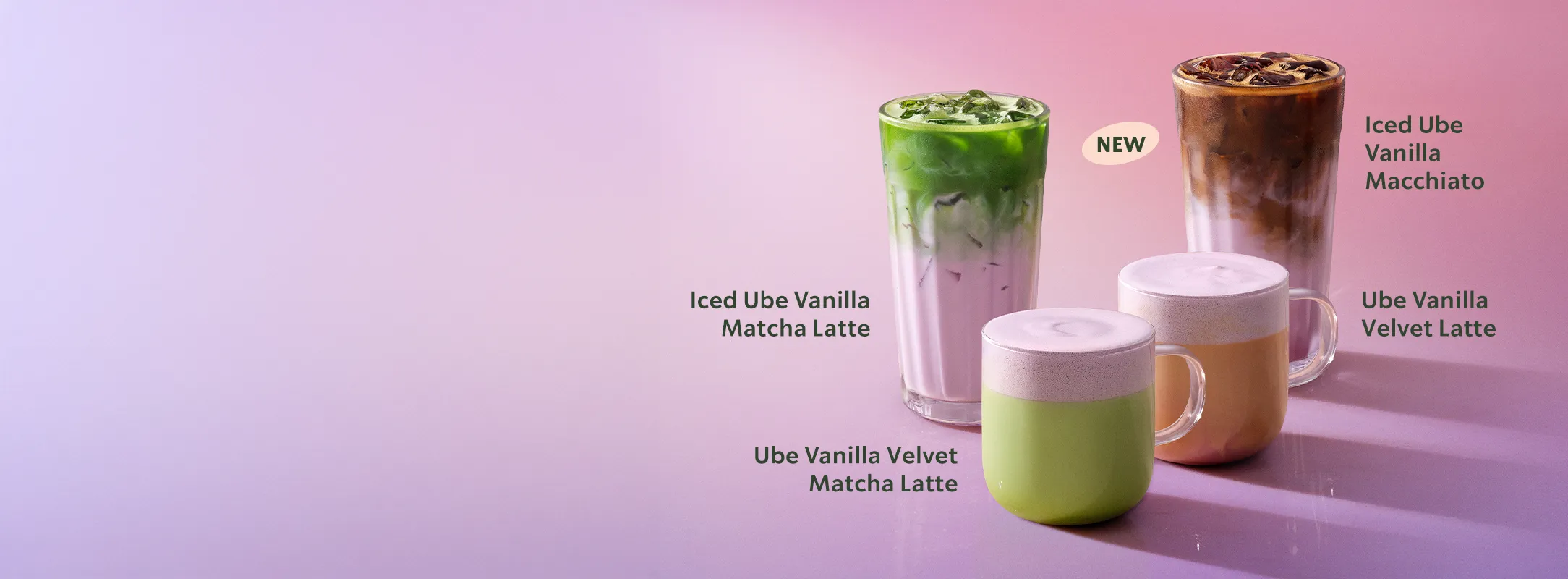 Four Starbucks drinks are displayed against a soft pink‑purple background. The drinks include an iced ube vanilla matcha latte and a hot ube vanilla velvet matcha latte on the left. On the right is an iced ube vanilla macchiato and a hot ube vanilla velvet latte. A small “NEW” label sits above the iced macchiato