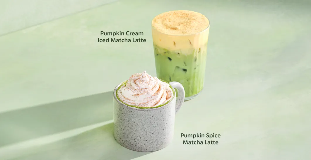 Two Starbucks pumpkin matcha drinks on a green background: a hot Pumpkin Spice Matcha Latte in a white mug topped with whipped cream, and a Pumpkin Cream Iced Matcha Latte in a clear glass filled with ice.